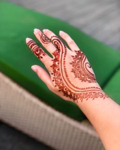 henna on a woman's hand from a street vendor at Johari bazaar