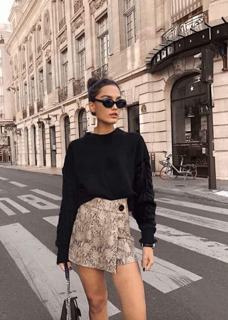 hip and trendy outfits for fall this snake skin skirt paired with a chunky black sweater is a classic for a date night or a girls lunch out. This city look is great for a trip to new york or a night out clubbing. 