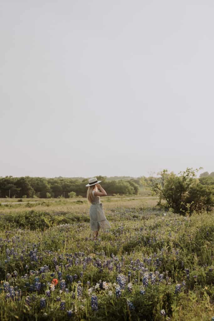 A pensive moment of a girl among the  bluebonnet flowers in Ennis, Texas