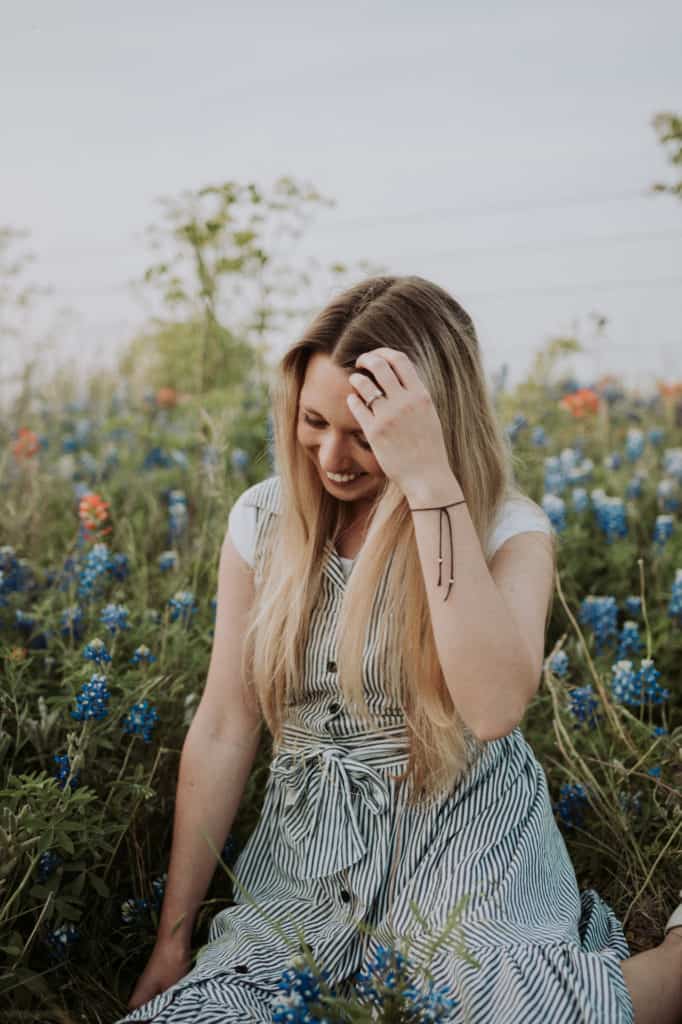 A girl sitting among blue wildflowers. In Ennis texas along the bluebonnet trail
