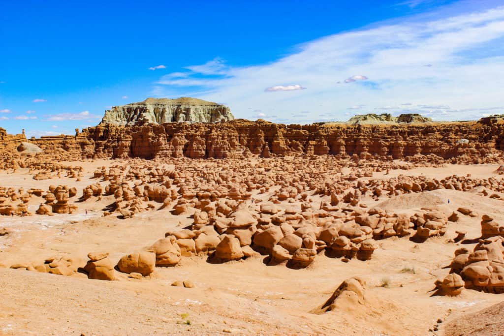 A valley filled with hoodoo rock formations in Goblin Valley State Park in Utah. A small drive will set you up with a day of exploration and freedom in this trail less area. A fun filled day trip from Salt Lake City means that it is easy to get to.