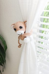 The details are what make a room. These monkey curtain tie backs are so cute and the perfect finishing touch. A gender neutral safari nursery is such a cute nursery theme! This safari nursery theme is fun, light and airy, plus absolutely adorable. There are a few travel nursery details thrown in and it is the happiest room in the house. I hope it helps you with your own nursery inspiration.