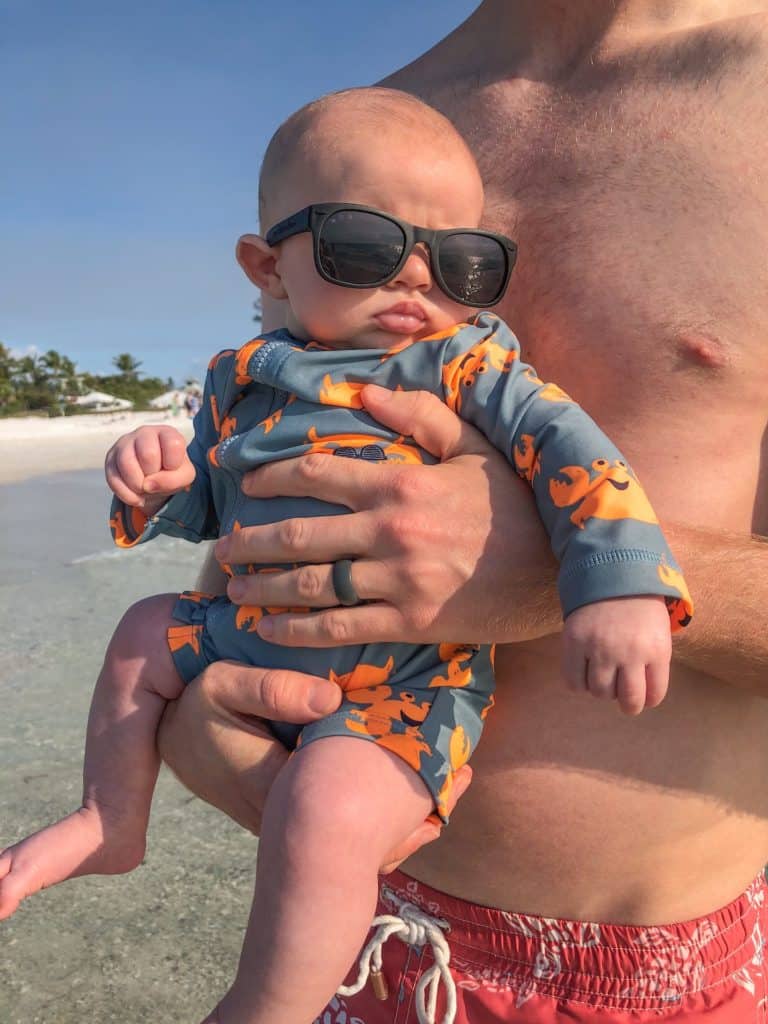 Cute baby in sunglasses and a swimsuit on Anna Maria Island. The water felt good on a hot sunny day. Anna Maria Island is the perfect place to bring your children for a family vacation. It is a very family friendly place and they will love playing on the beach.