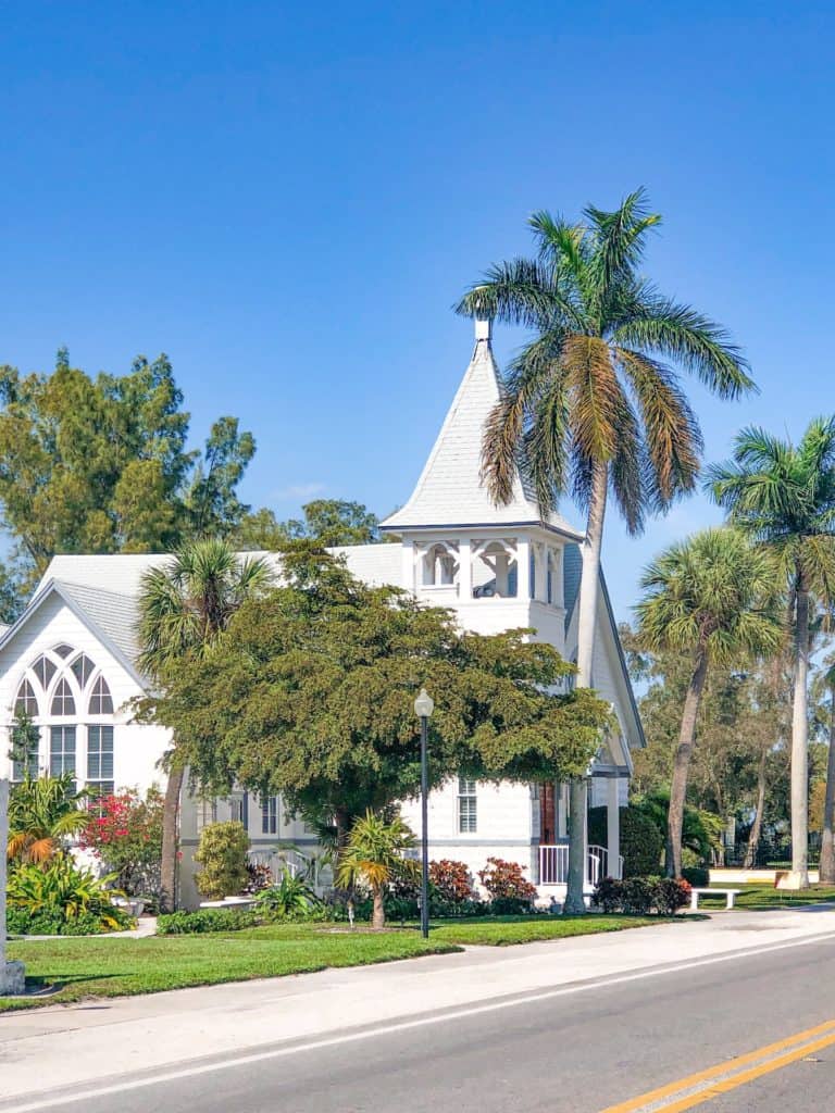 Beautiful white church located on Anna Maria Island. Surrounded by beautiful gardens and palm trees.