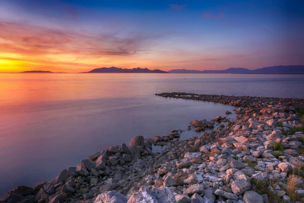 A stunningly beautiful sunset over the Great Salt Lake in Utah. The rocks and calm salty waters make for a very peaceful setting.