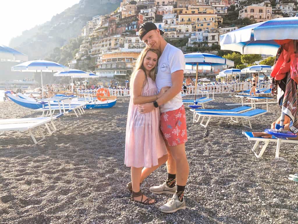 A young couple traveling together in Positano, Italy