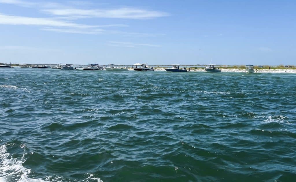 Boats on a sand bar as seen from the egmont key ferry