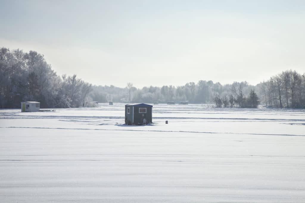 An ice fishing cabin on the lake. Ice fishing on Lake Erie in the US.