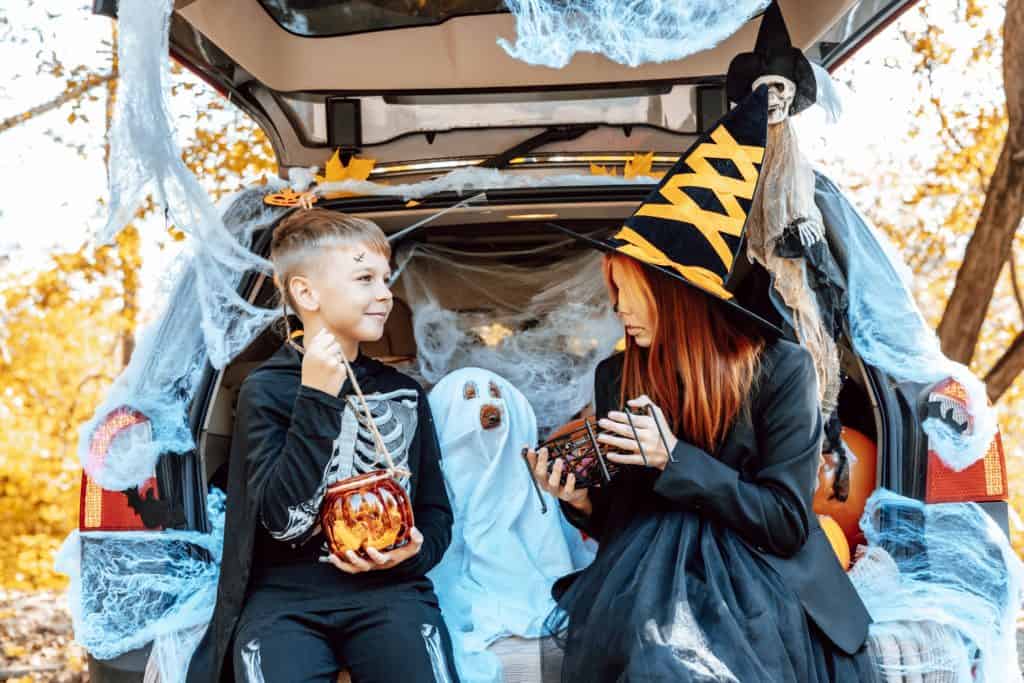 Trunk or treating events in Tampa are a fun alternative to trick or treating. These kids and their dog are sitting in the car truck waiting for the event to start in Tampa.