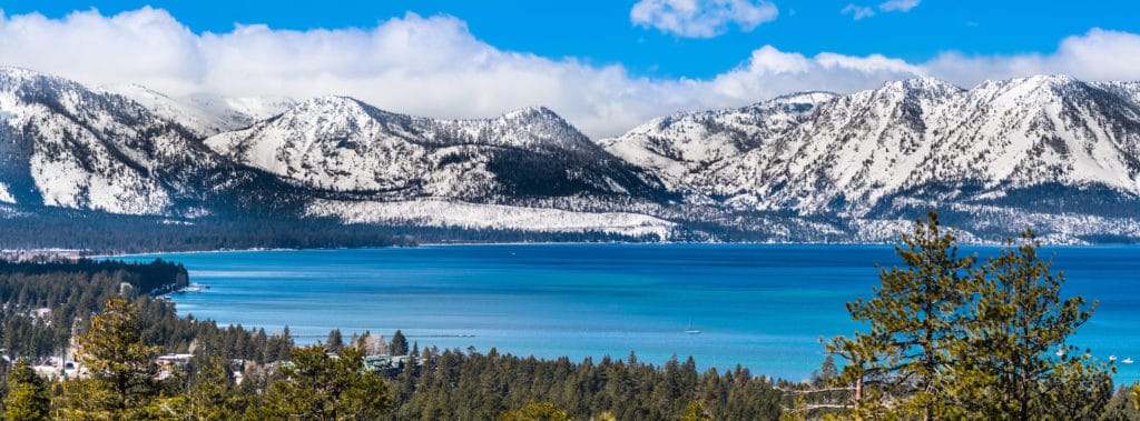panoramic view of lake Tahoe in the winter covered in snow.