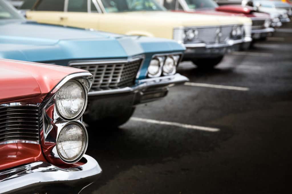 Classic cars lined up in a parking lot ready to be seen. There are so many vintage cars in the car museums throughout Florida.