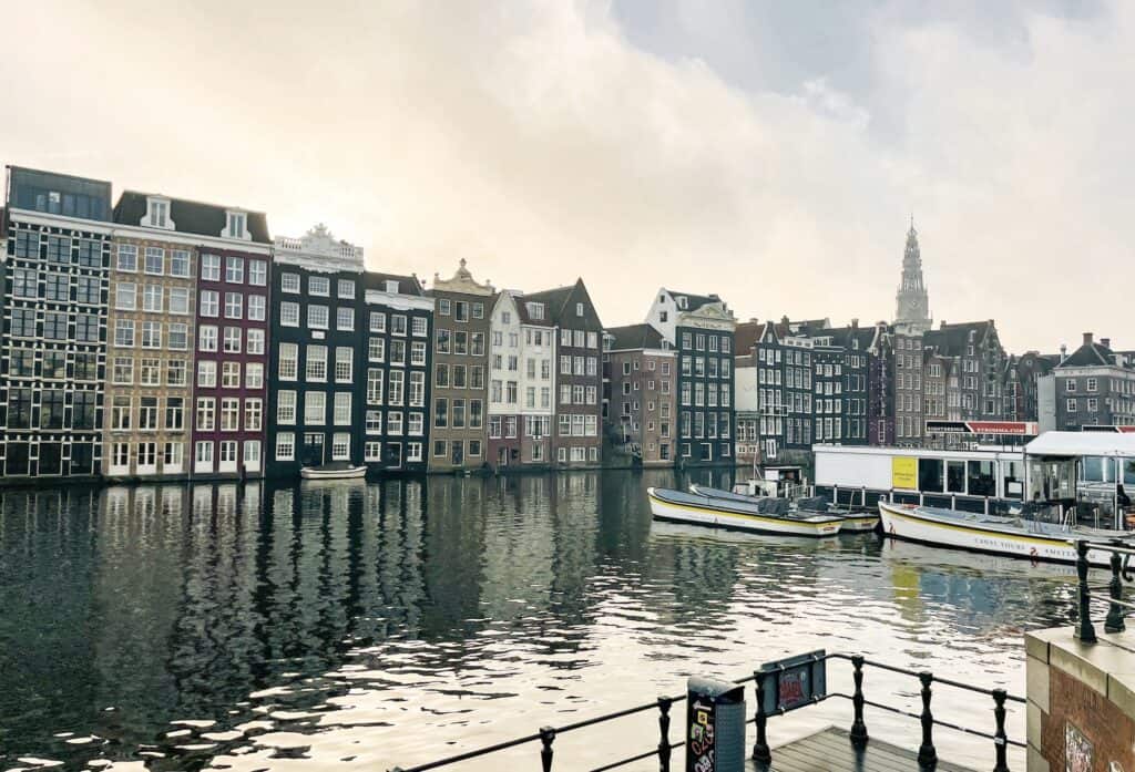 A view of the Damrak area in downtown Amsterdam where the famous gingerbread houses line the Canal.