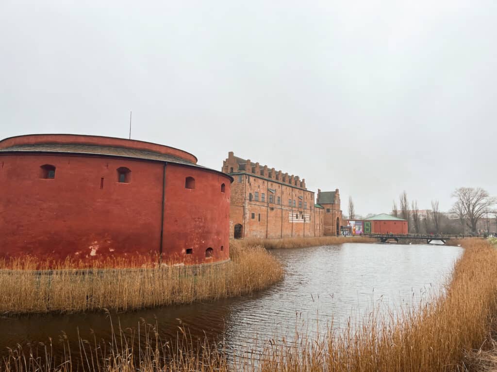 Malmö Castle or Malmöhus is an old castle turned museum that should be at the top of your list of things to do in Malmö. The Large brick castle is surrounded by a moat with swans swimming in it.