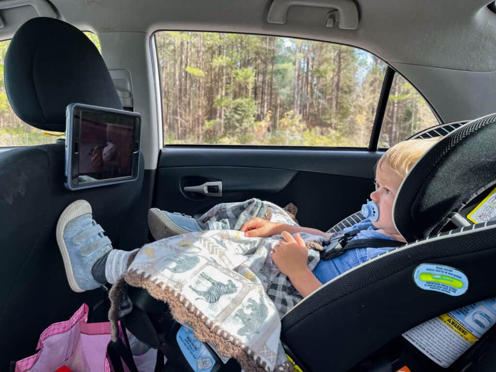 When surviving road trips with toddlers screen time is a great way to pass the time.