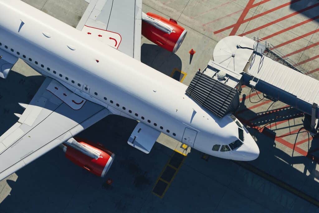 An airplane parked at the gate viewed from above.