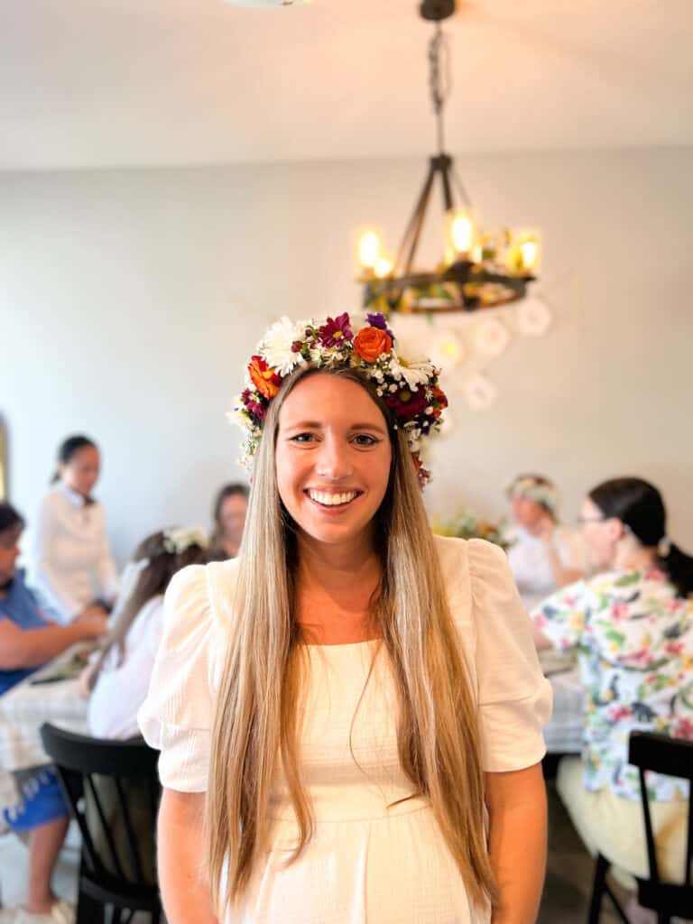 A woman smiling wearing a flower crown