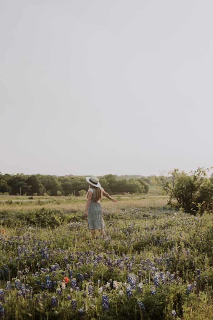 A woman frolicking in a field of flowers