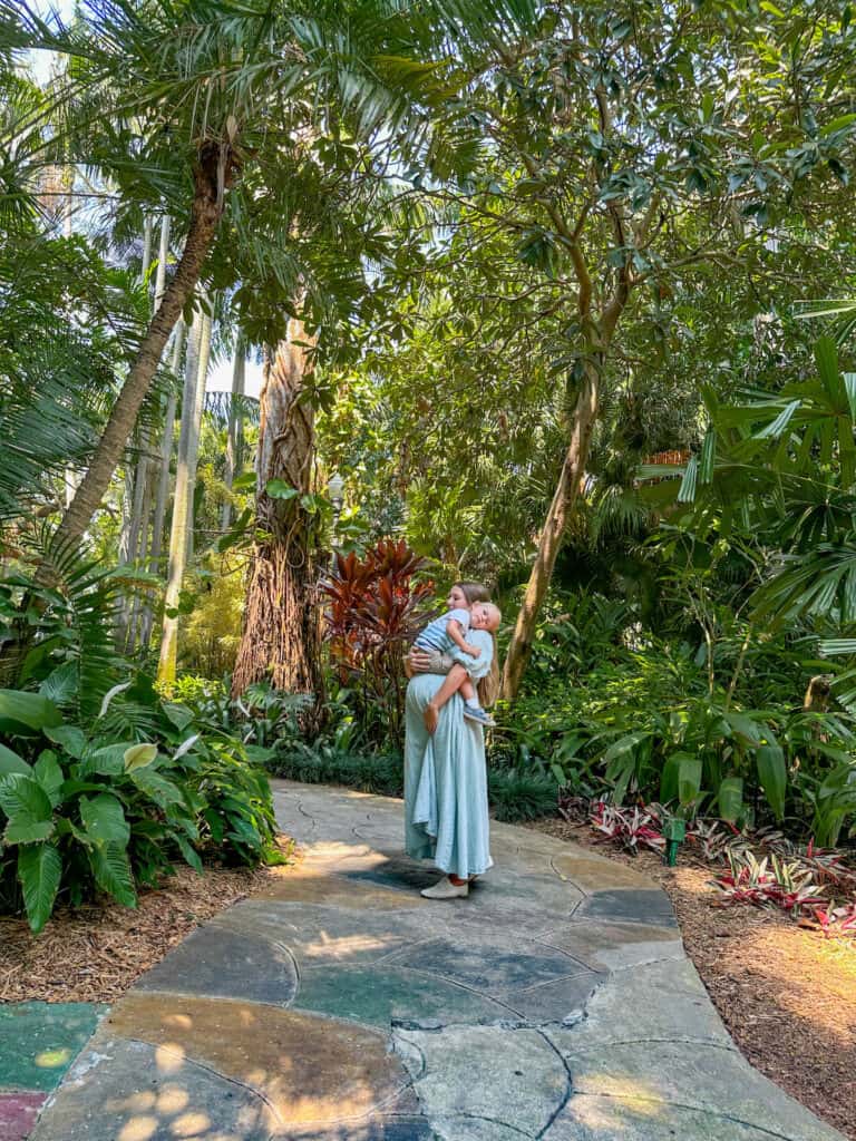 Mother and son walking along the walking trail inside the Sunken Gardens. Your guide to the Sunken Gardens outside Tampa gives all the tips you need for a fun family outing.