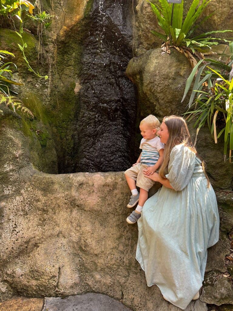 Mother and son sitting by one of the many water features in the sunken garden in St. Pete. 