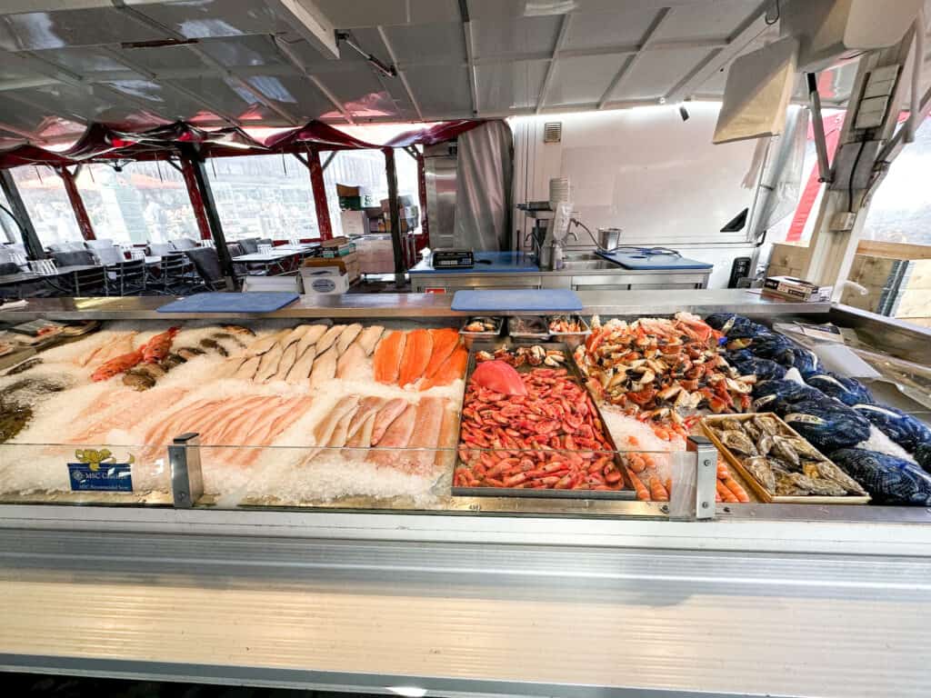Many types of fish, prawns and other seafood laid out in the Bergen Fish Market.