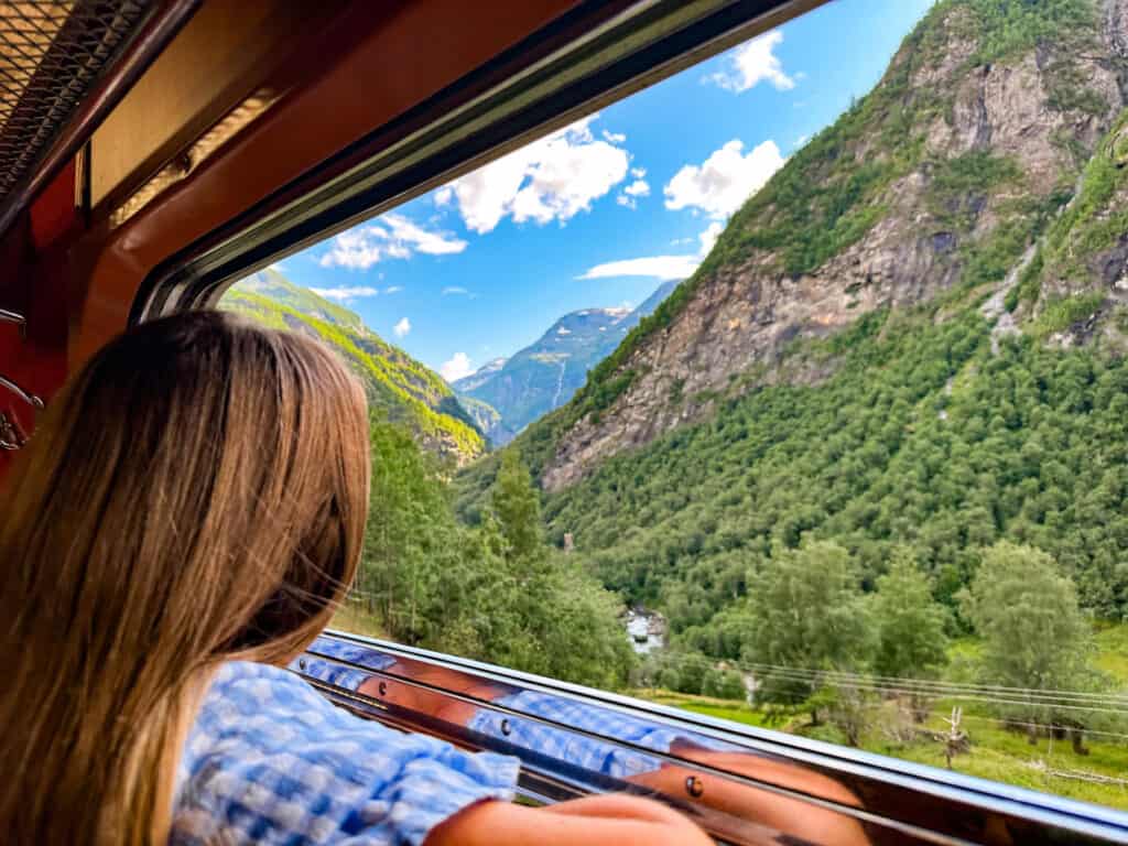 During norway on a nutshell tours you go on the Flåmsbana train ride. The views from the windows of the surrounding mountains and rivers are breathtaking.