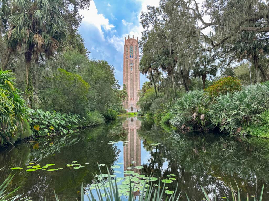 the singing tower in Bok Tower Gardens viewed from the reflecting pond