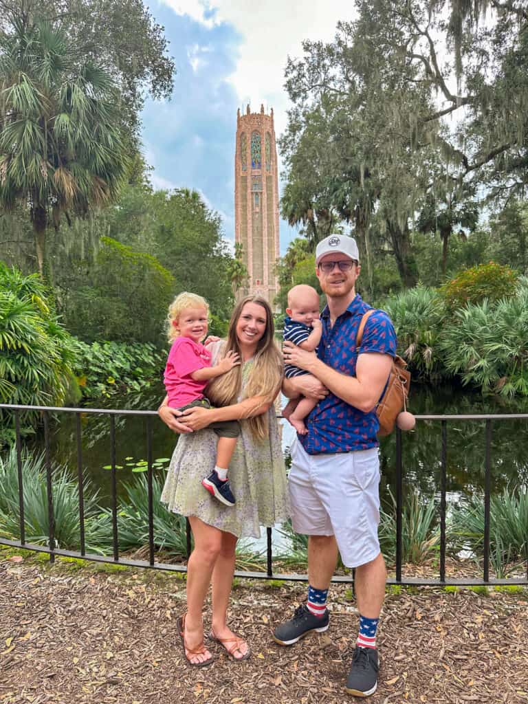 Young family posing in front of the singing tower at Bok Tower Gardens