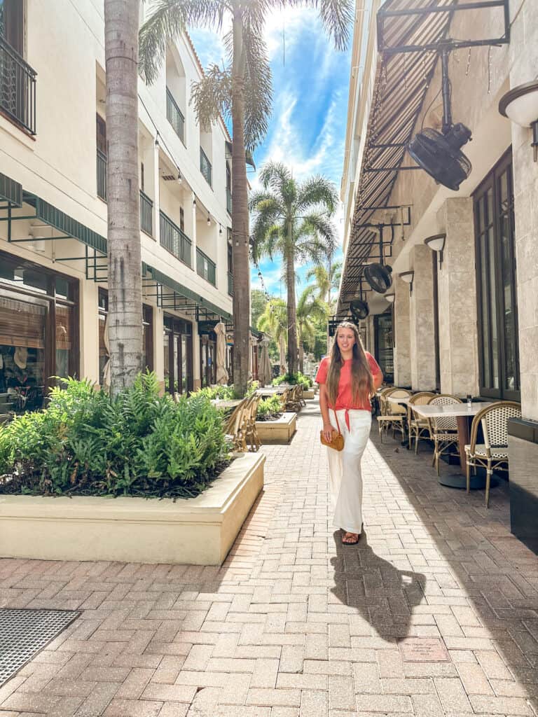 A woman walking and shopping on Fifth Ave in Naples Florida a must do on any Naples itinerary