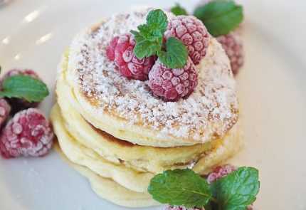 Fluffy pancakes topped with raspberries